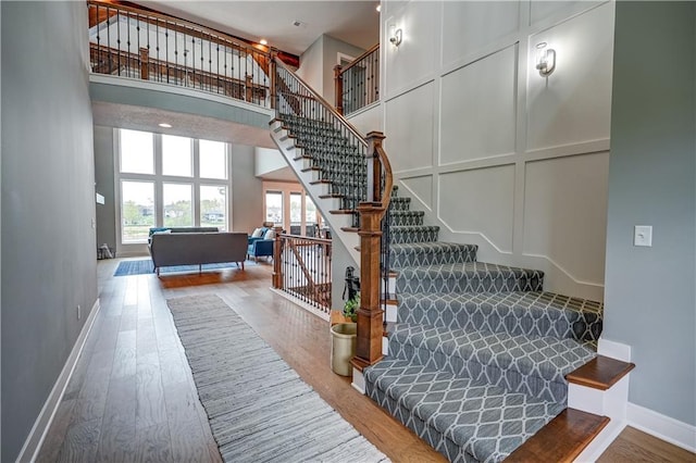 18 Black Hawk Dr, Lake Winnebago, MO 64034 - staircase with wood finished floors, a high ceiling, and baseboards