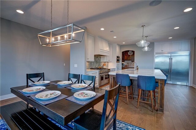 18 Black Hawk Dr, Lake Winnebago, MO 64034 - dining space with dark wood-type flooring, recessed lighting, baseboards, and a chandelier