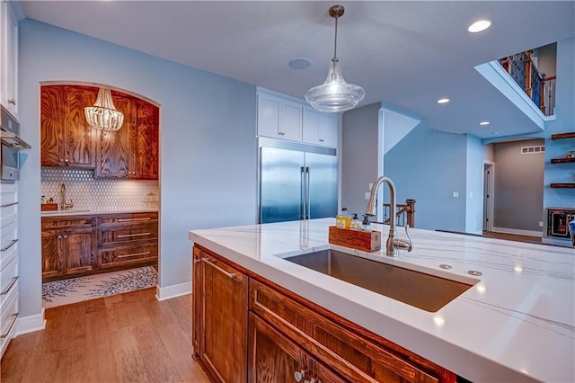 18 Black Hawk Dr, Lake Winnebago, MO 64034 - kitchen with stainless steel appliances, a sink, light wood finished floors, pendant lighting, and recessed lighting