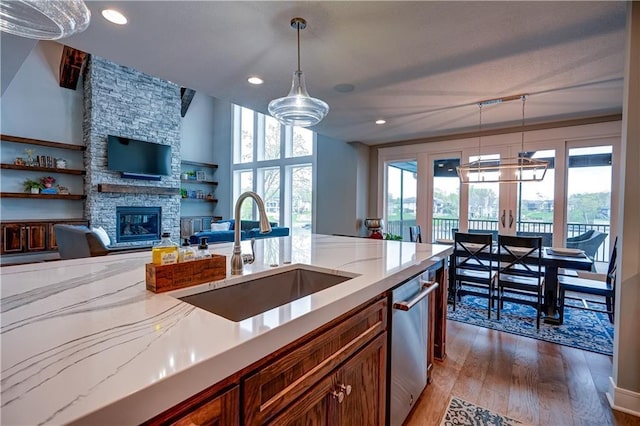 18 Black Hawk Dr, Lake Winnebago, MO 64034 - kitchen featuring a sink, dishwasher, a fireplace, hardwood / wood-style flooring, and hanging light fixtures