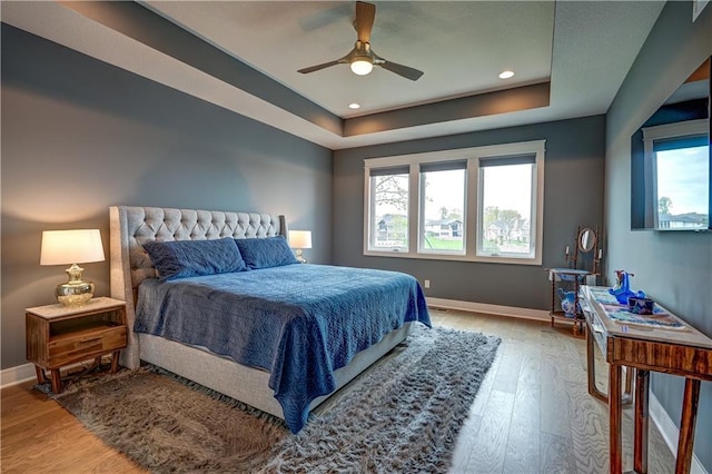 18 Black Hawk Dr, Lake Winnebago, MO 64034 - bedroom featuring baseboards, light wood finished floors, a raised ceiling, recessed lighting, and ceiling fan