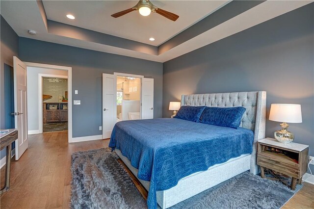 18 Black Hawk Dr, Lake Winnebago, MO 64034 - bedroom featuring wood finished floors, baseboards, recessed lighting, a raised ceiling, and ensuite bath