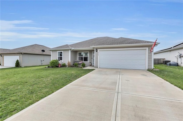 ranch-style home with an attached garage, driveway, central AC unit, and a front lawn