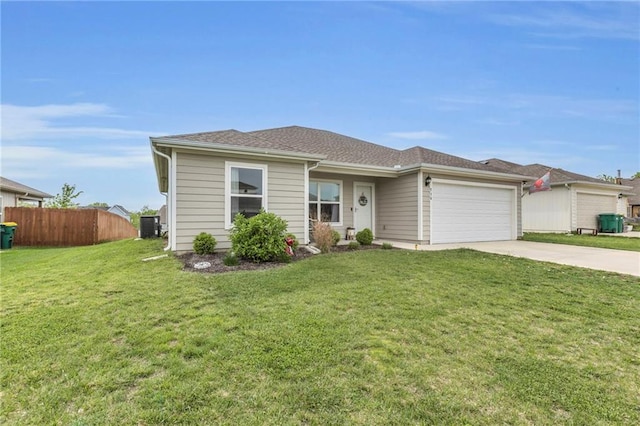ranch-style house with fence, an attached garage, concrete driveway, and a front lawn