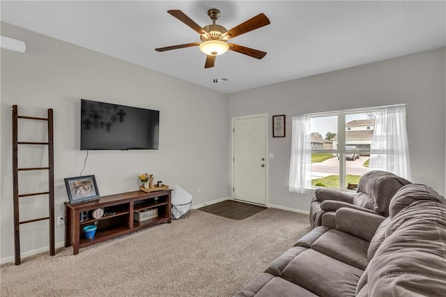 carpeted living room with a ceiling fan and baseboards