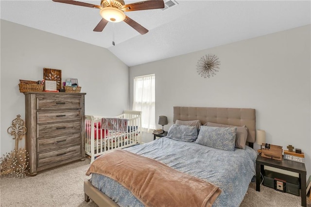 bedroom with carpet floors, ceiling fan, lofted ceiling, and visible vents
