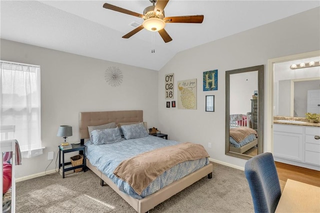 bedroom with baseboards, ceiling fan, vaulted ceiling, and light carpet