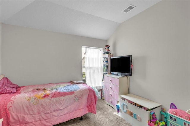 bedroom with visible vents, light carpet, and lofted ceiling