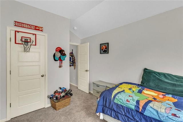 carpeted bedroom featuring baseboards and vaulted ceiling