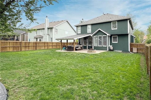 4200 Grand Ave, Leavenworth, KS 66048 - rear view of house with a yard, a patio, a fenced backyard, and an outdoor living space with a fire pit