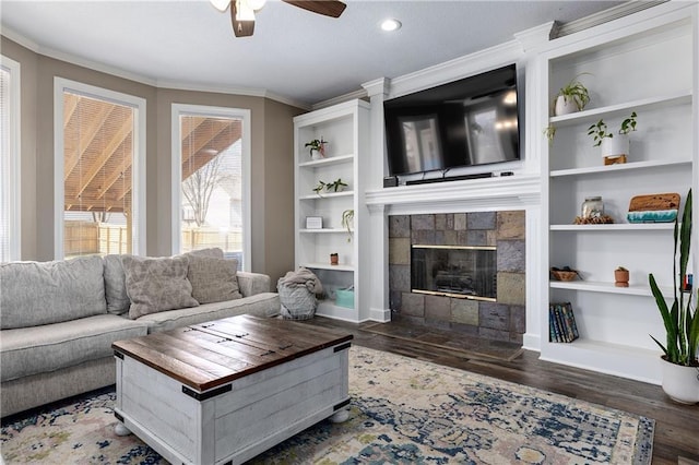 4200 Grand Ave, Leavenworth, KS 66048 - living area featuring a tiled fireplace, ornamental molding, ceiling fan, and wood finished floors
