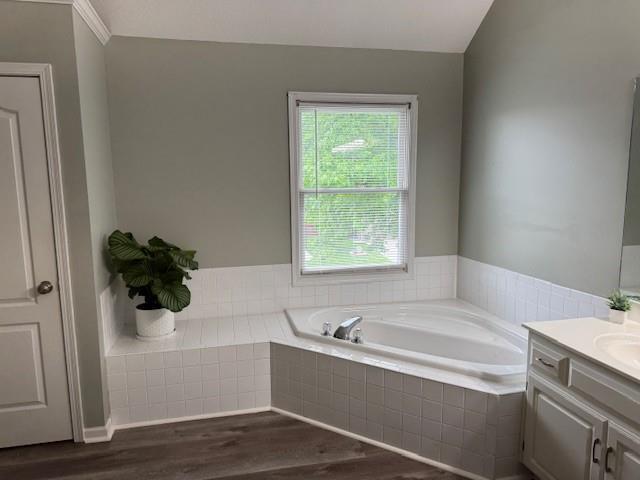 4200 Grand Ave, Leavenworth, KS 66048 - full bath with vanity, a garden tub, plenty of natural light, and wood finished floors