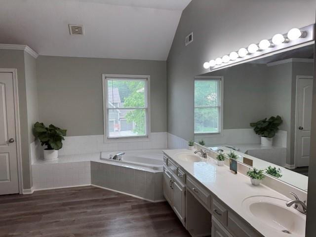 4200 Grand Ave, Leavenworth, KS 66048 - full bathroom with a garden tub, double vanity, vaulted ceiling, and wood finished floors