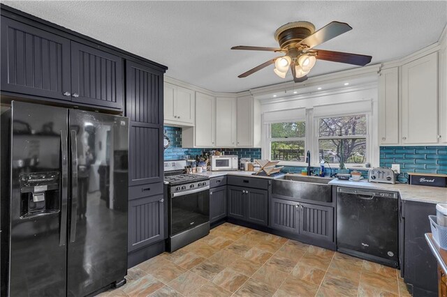 kitchen featuring decorative backsplash, ceiling fan, white cabinets, a sink, and black appliances