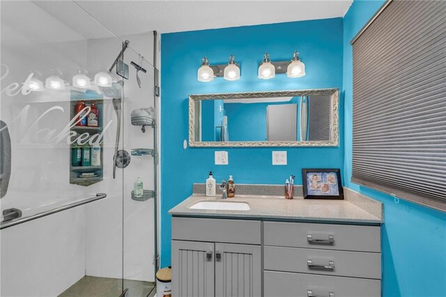 bathroom with vanity and a shower stall