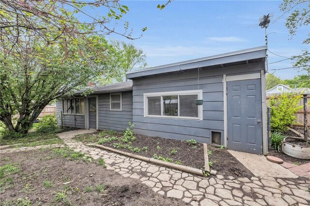 rear view of property with fence
