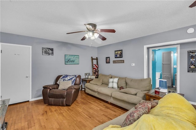 524 Truman St, Pomona, KS 66076 - living room featuring ceiling fan, wood finished floors, a textured ceiling, and baseboards