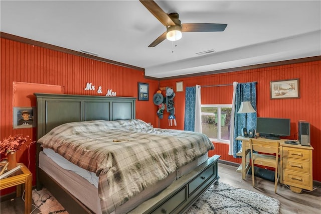 524 Truman St, Pomona, KS 66076 - bedroom featuring wooden walls, wood finished floors, and ceiling fan