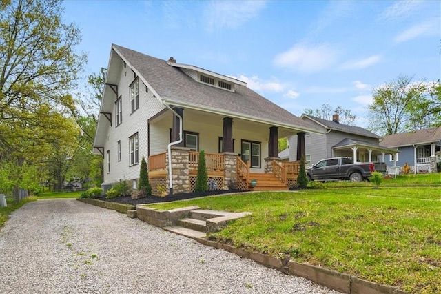 507 N Pearl St, Paola, KS 66071 - view of front facade with roof with shingles, covered porch, a chimney, and a front lawn