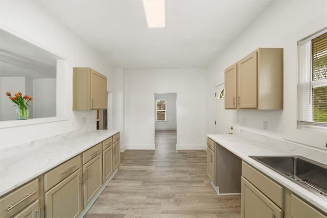507 N Pearl St, Paola, KS 66071 - kitchen featuring baseboards, a sink, and light wood finished floors