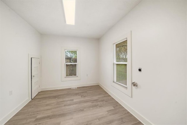 507 N Pearl St, Paola, KS 66071 - empty room with baseboards and light wood finished floors