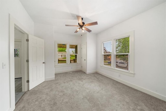 507 N Pearl St, Paola, KS 66071 - unfurnished bedroom featuring baseboards, multiple windows, and carpet