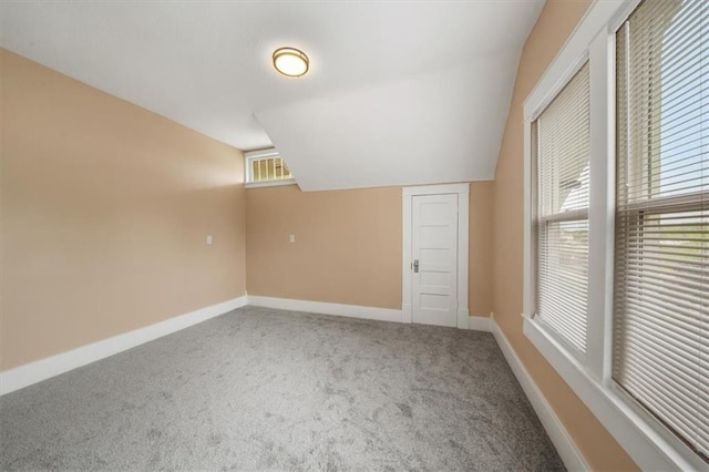 507 N Pearl St, Paola, KS 66071 - carpeted empty room with baseboards and vaulted ceiling