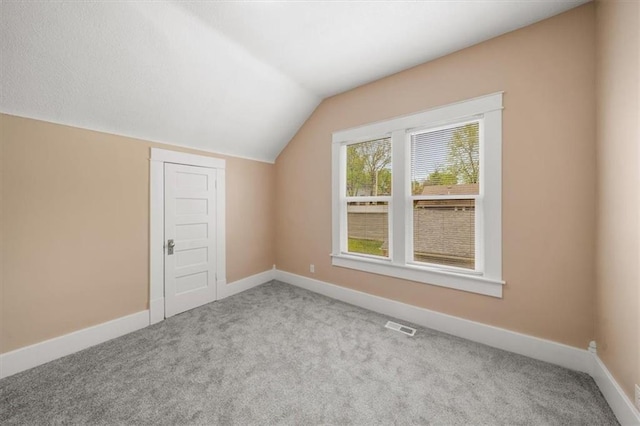 507 N Pearl St, Paola, KS 66071 - bonus room featuring visible vents, baseboards, carpet floors, and lofted ceiling