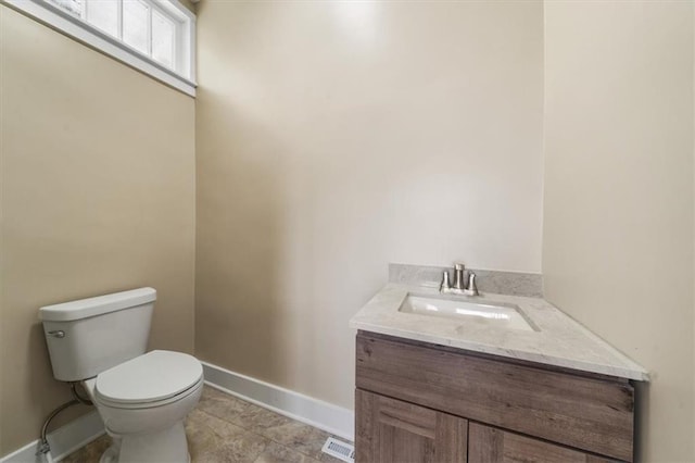 507 N Pearl St, Paola, KS 66071 - half bathroom with visible vents, tile patterned flooring, baseboards, vanity, and toilet