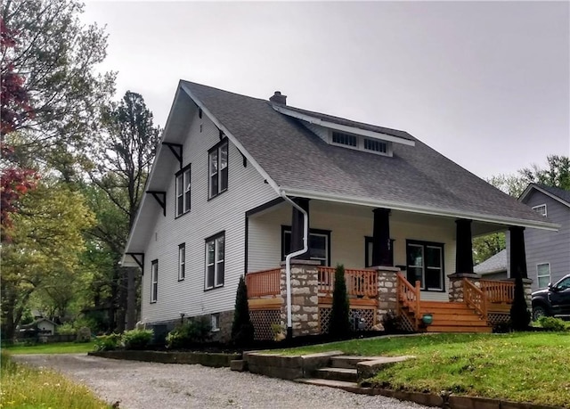507 N Pearl St, Paola, KS 66071 - view of front of home featuring a porch, a front yard, a chimney, and roof with shingles