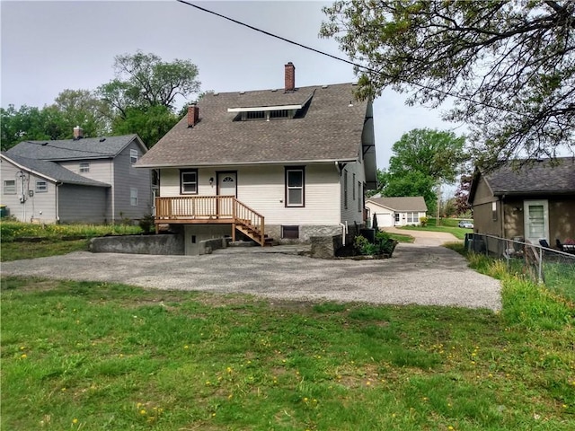 507 N Pearl St, Paola, KS 66071 - rear view of house featuring a yard, fence, a chimney, and roof with shingles