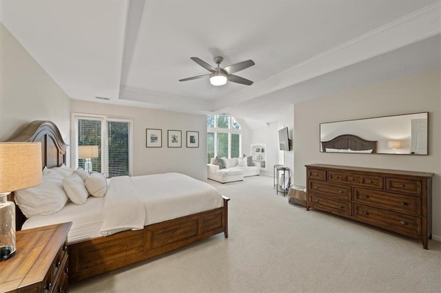 bedroom featuring light colored carpet, a raised ceiling, a ceiling fan, baseboards, and visible vents