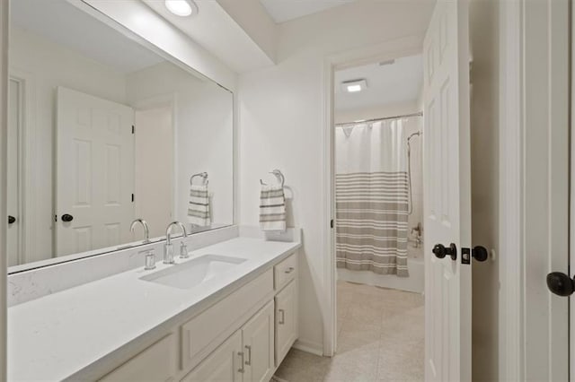 bathroom with baseboards, tile patterned flooring, and vanity