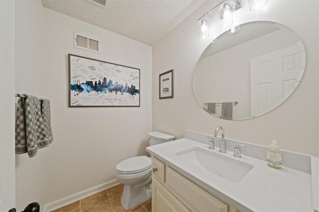 half bathroom with vanity, toilet, a textured ceiling, baseboards, and visible vents