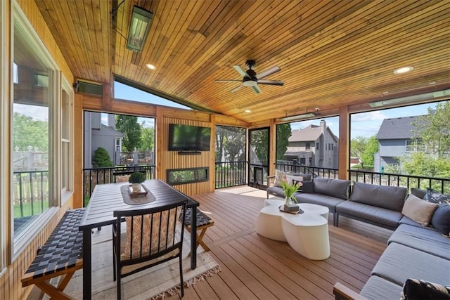 sunroom / solarium with an outdoor living space, ceiling fan, a residential view, and outdoor dining space
