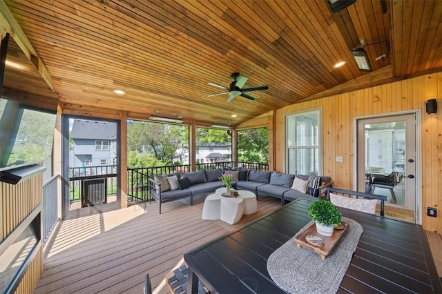 sunroom with ceiling fan and outdoor lounge area