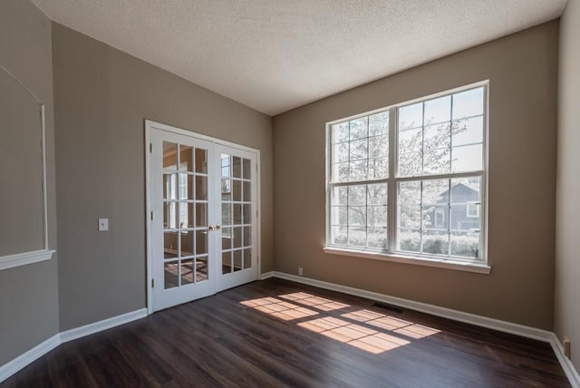 6512 N Fisk Ct, Kansas City, MO 64151 - unfurnished room with french doors, dark wood-type flooring, baseboards, healthy amount of natural light, and a textured ceiling