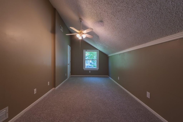 6512 N Fisk Ct, Kansas City, MO 64151 - additional living space featuring vaulted ceiling, a textured ceiling, ceiling fan, carpet flooring, and baseboards
