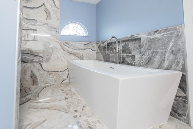 6512 N Fisk Ct, Kansas City, MO 64151 - full bath featuring a freestanding bath, tile walls, and marble finish flooring