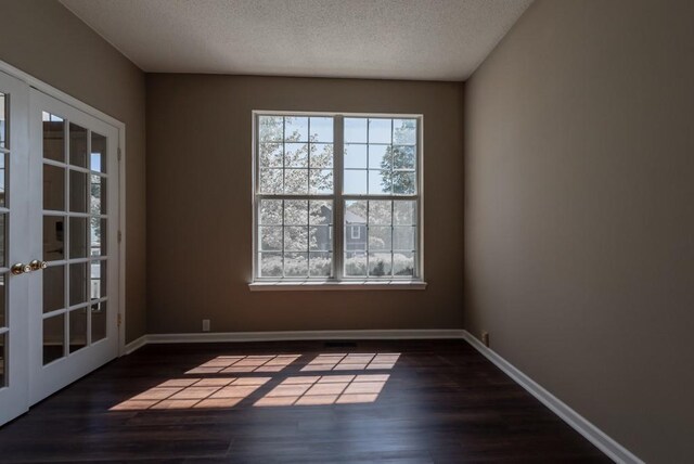 6512 N Fisk Ct, Kansas City, MO 64151 - spare room with french doors, wood finished floors, and a textured ceiling