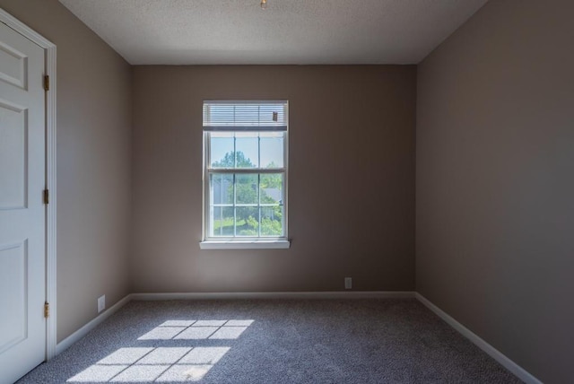 6512 N Fisk Ct, Kansas City, MO 64151 - carpeted empty room featuring baseboards and a textured ceiling