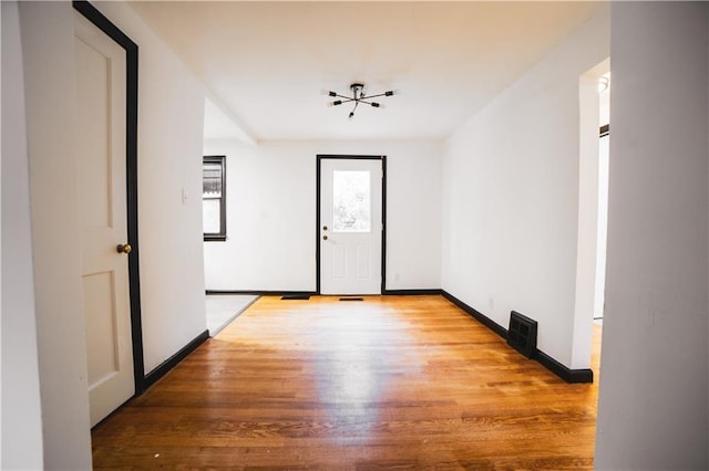unfurnished room featuring light wood-type flooring and baseboards