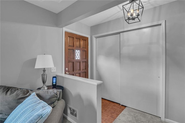 entryway with a chandelier