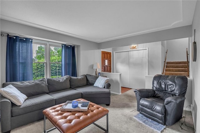 living area featuring carpet and stairway