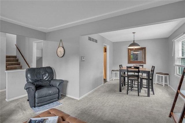dining area featuring carpet flooring and baseboards