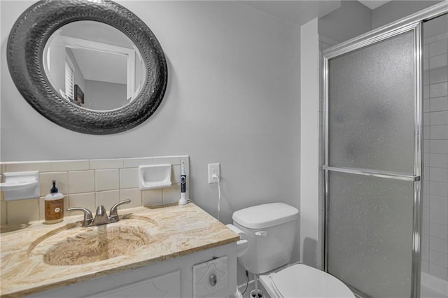 full bath featuring a stall shower, toilet, and vanity