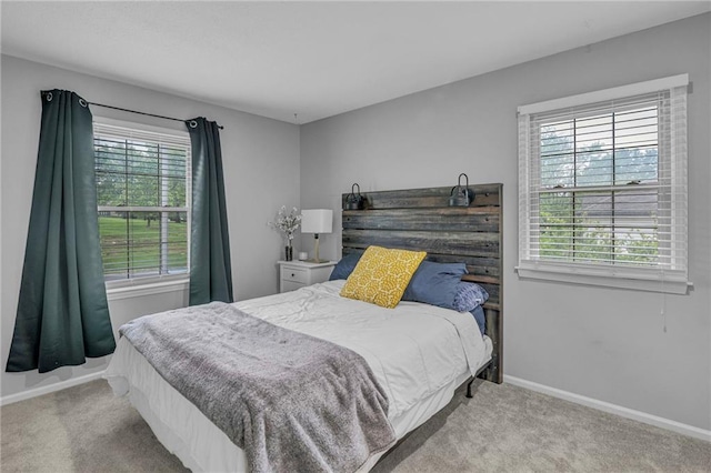 bedroom featuring carpet and baseboards