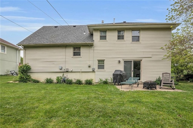 back of house with an outdoor fire pit, a yard, a patio area, and roof with shingles