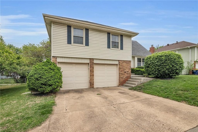 split level home featuring brick siding, a garage, a front yard, and concrete driveway