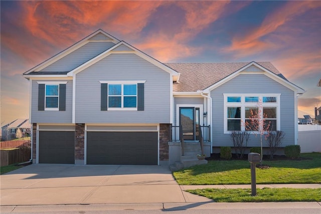 2200 NW Hedgewood Dr, Grain Valley, MO 64029 - view of front of property with an attached garage, driveway, and stone siding